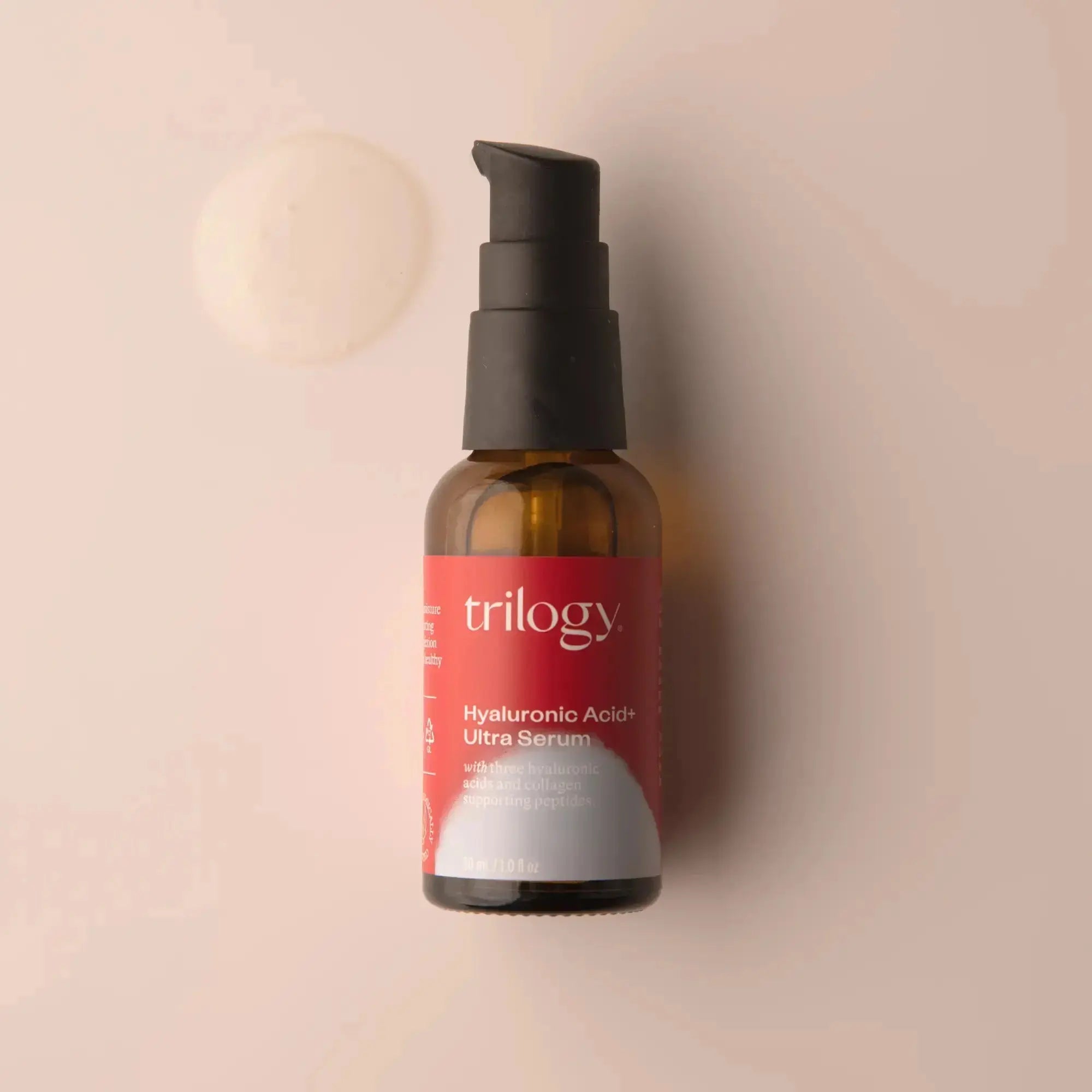 A pump bottle of Trilogy Hyaluronic Acid+ Ultra Serum on a light background, with a cap and label visible.