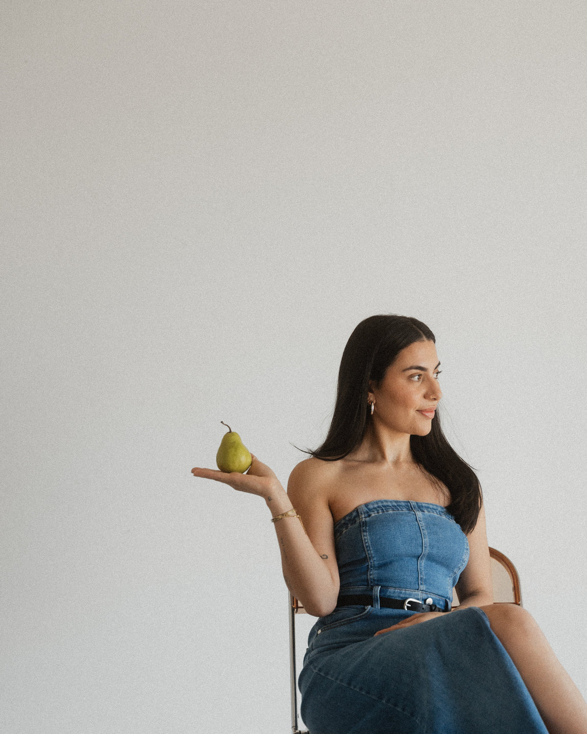 Dr Sheyda, naturopathic doctor, holding a pear