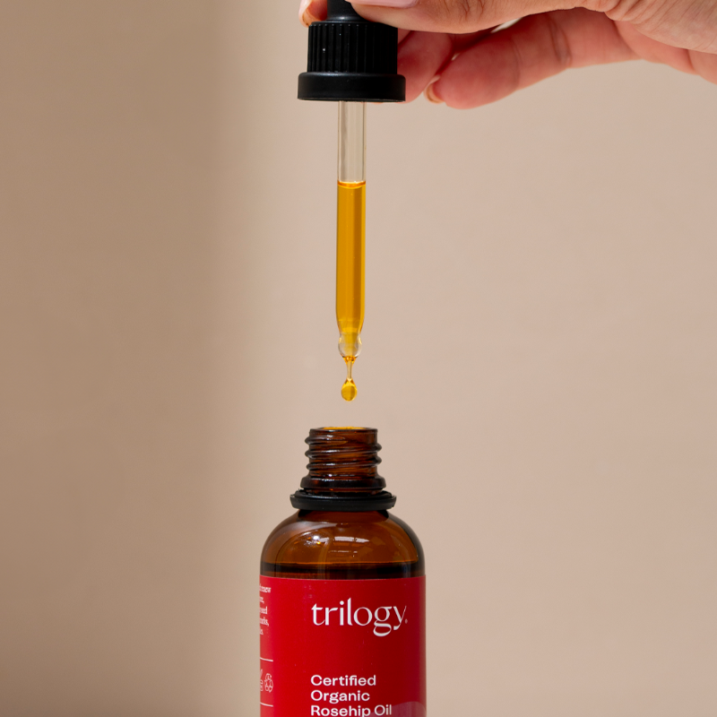 Certified organic rosehip oil in glass bottle with dropper